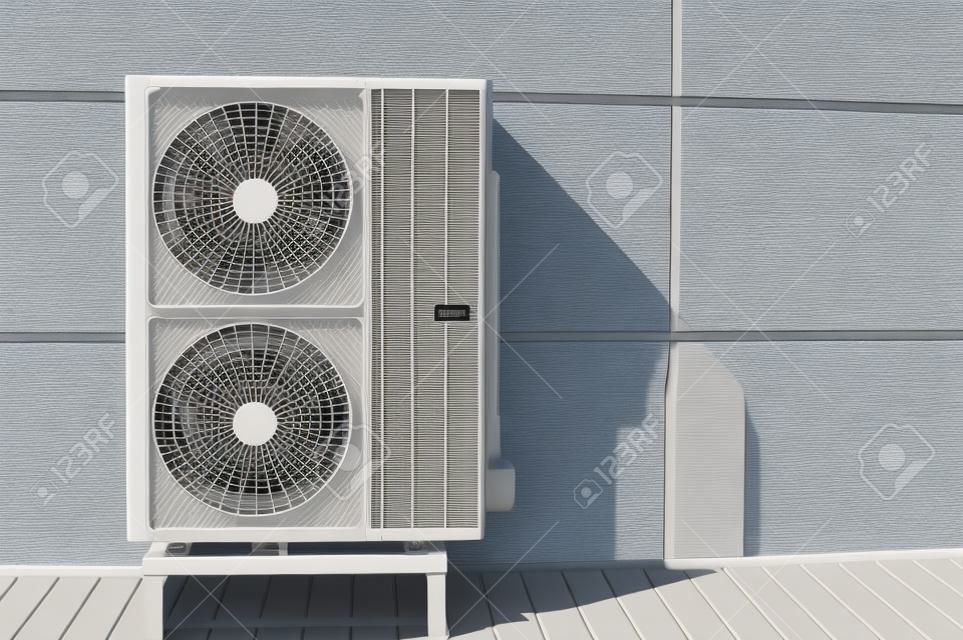 Exterior air conditioning unit on a wall.