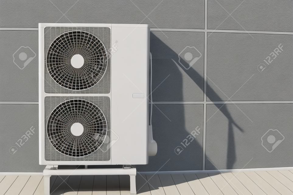 Exterior air conditioning unit on a wall.