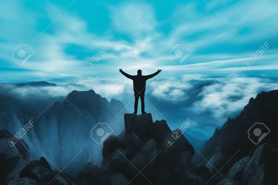 Man standing on top of mountain with his arms wide open. Generative AI.