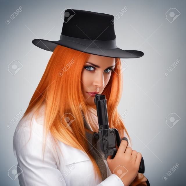 Attractive cowgirl with gun on white background