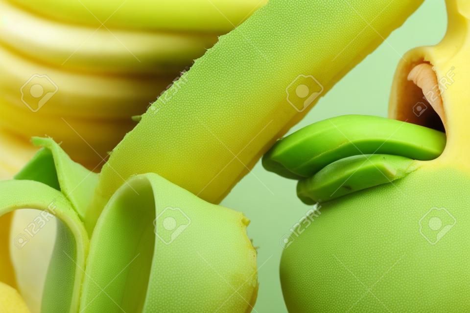 Close-up female mouth licking peeled banana 