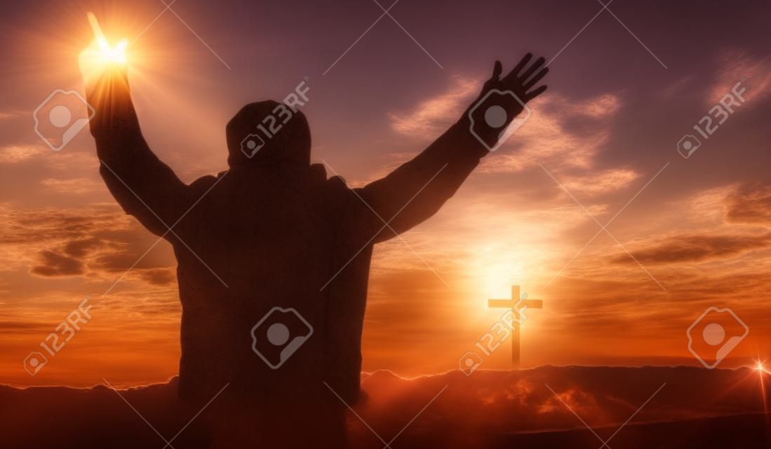 Religious concept: christian worship on cross sunrise background