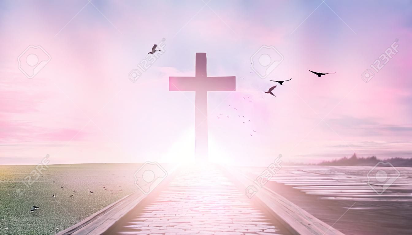 Religious concept: Silhouette cross and birds flying on sunrise background
