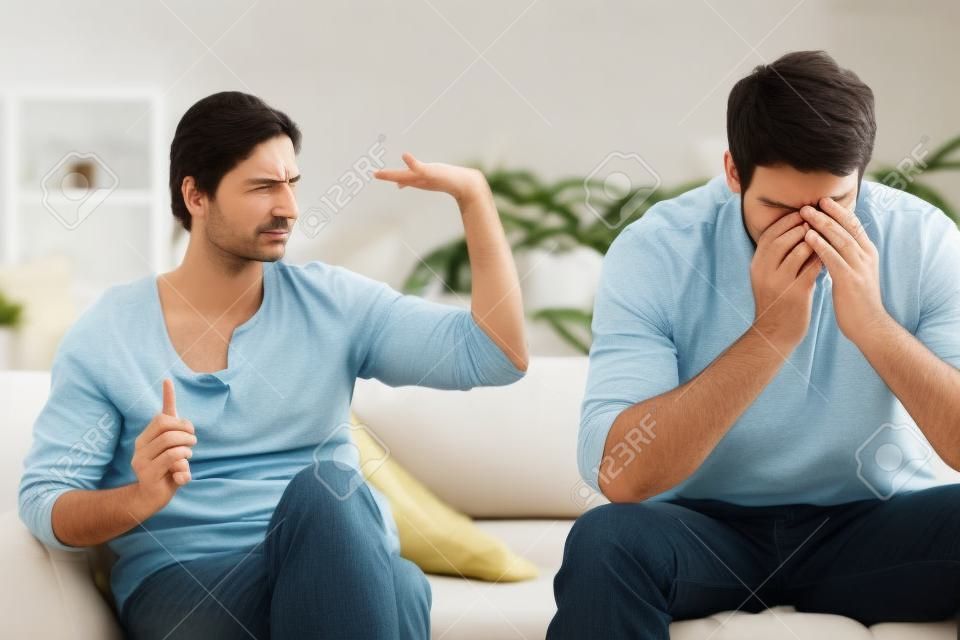 Man being tired of arguing with his wife in their living room