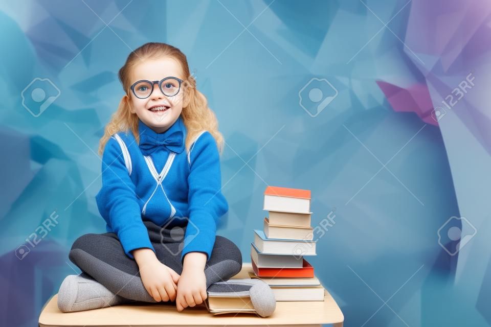 Cute pupil sitting on table  against angular design
