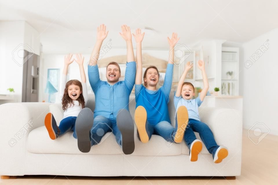 Happy family sitting on sofa and enjoying at home