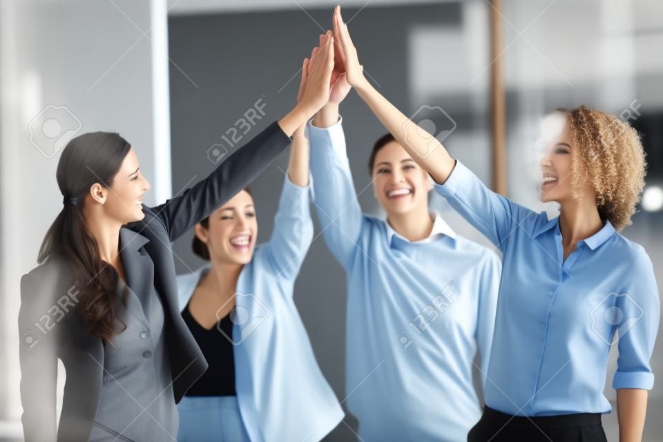 Business people giving high five to each other in office