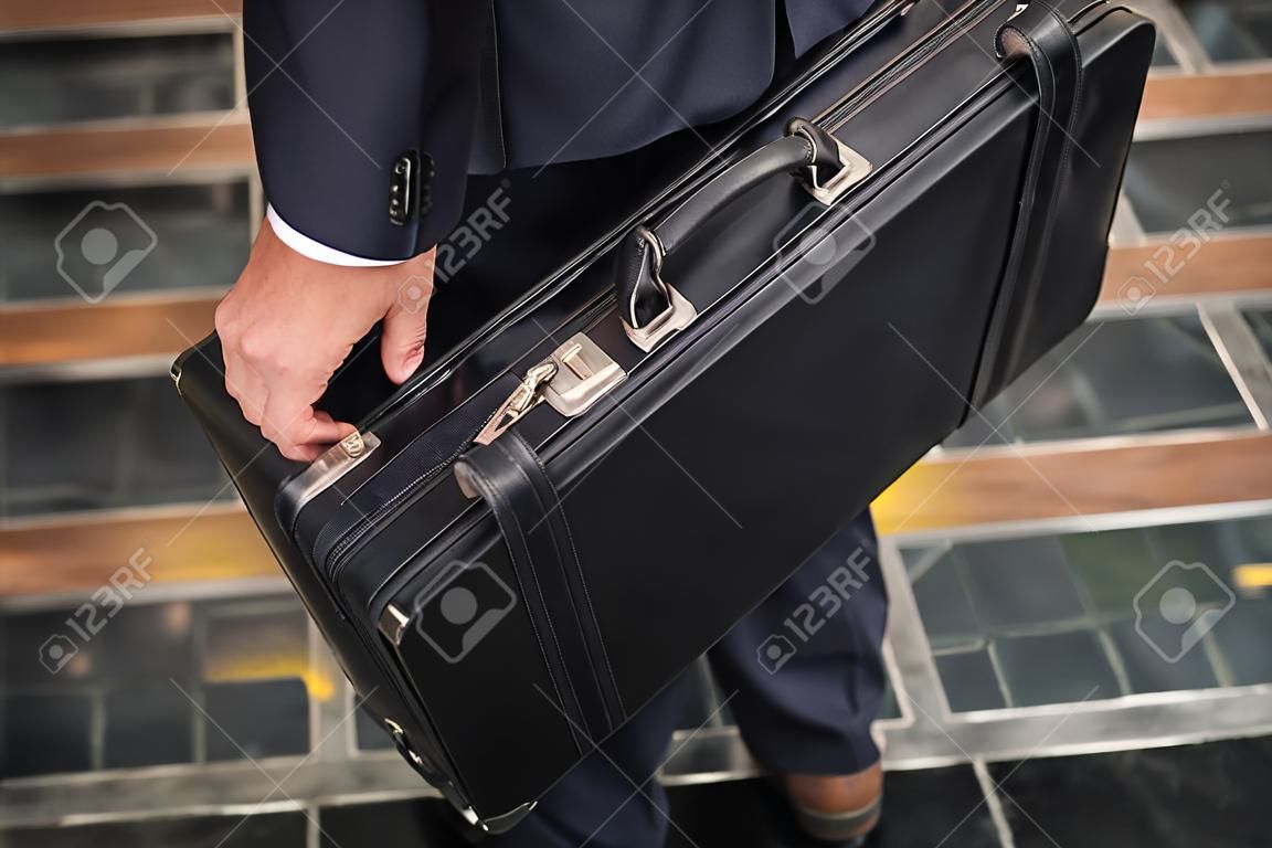 Close-up of a business man carrying briefcase