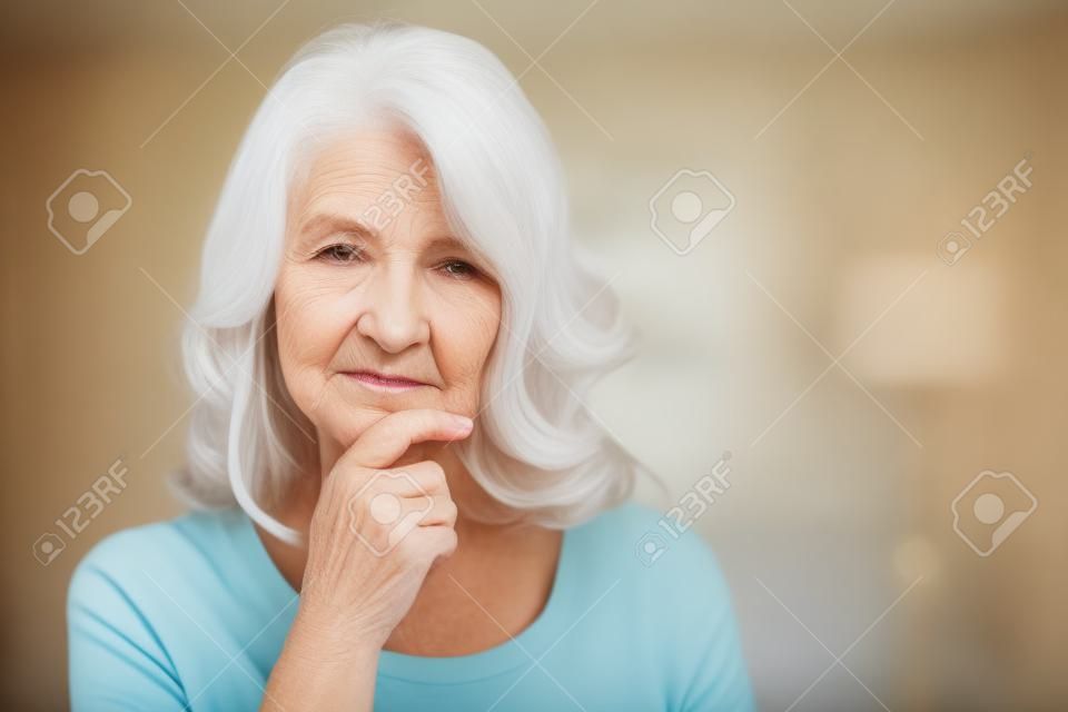 Portrait of thoughtful senior woman at home
