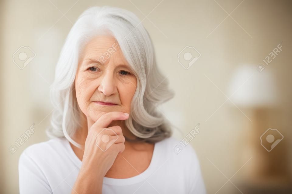 Portrait of thoughtful senior woman at home