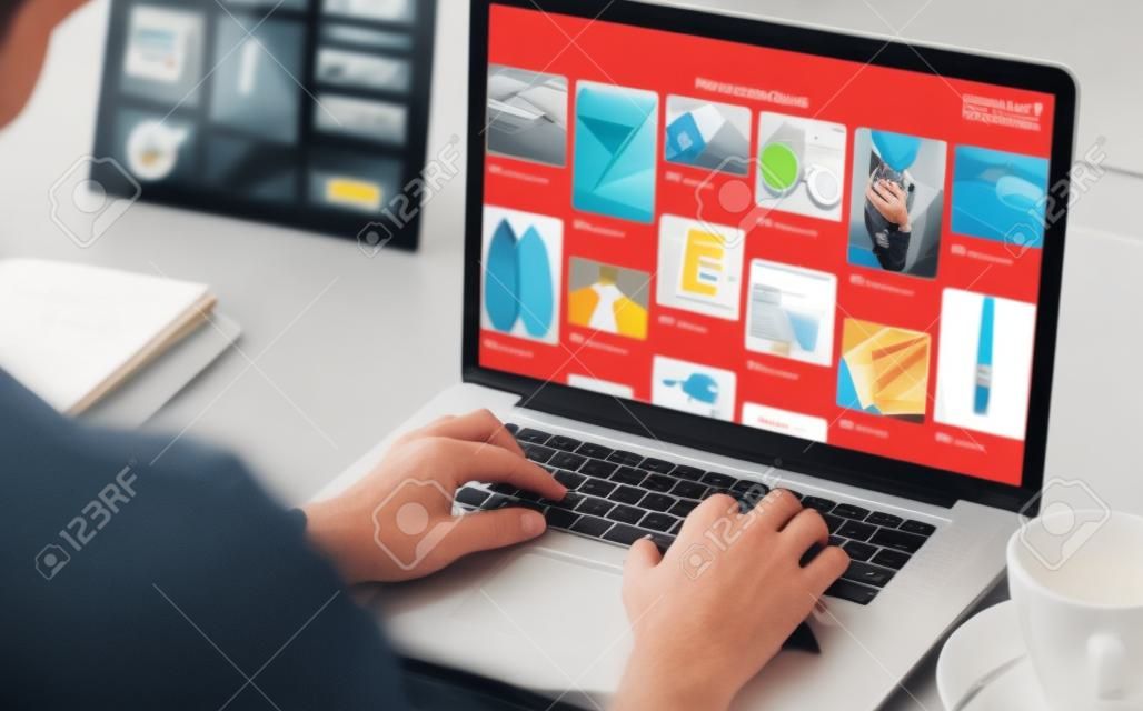 Composite image of website page against cropped image of man working on laptop