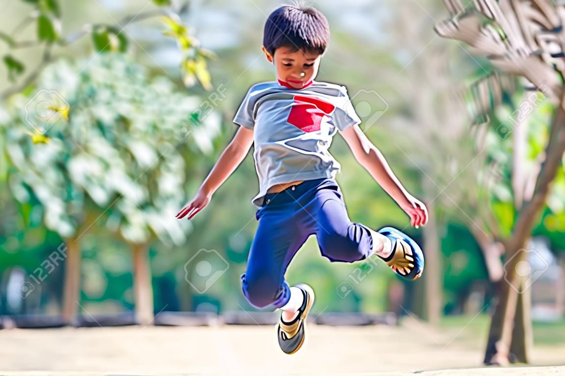 Little boy jumping in the park 