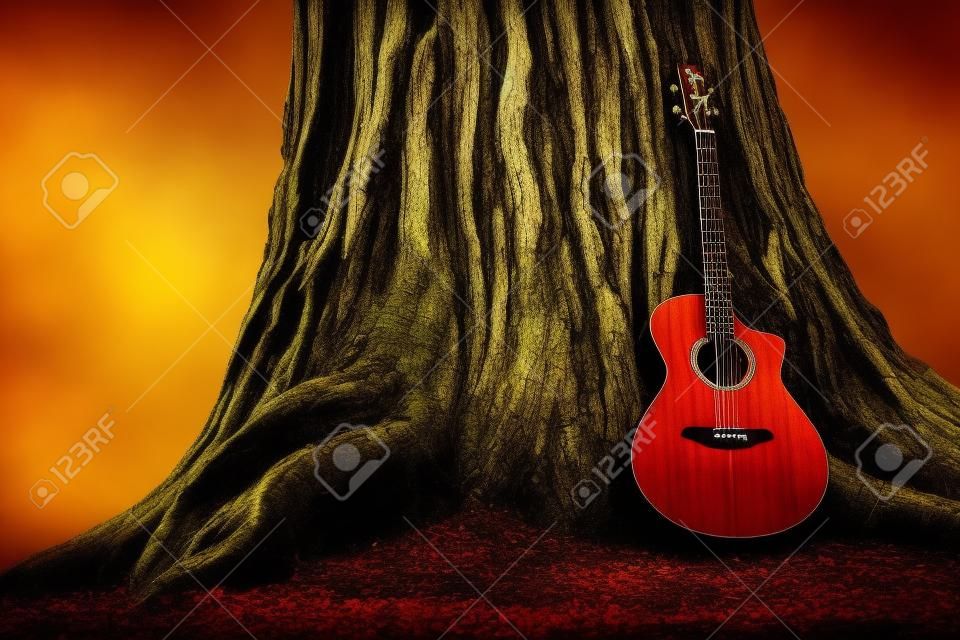 原聲吉他和舊樹。音樂主題與木吉他。