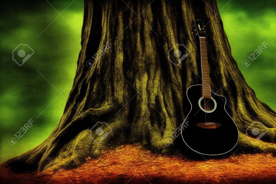 原聲吉他和舊樹。音樂主題與木吉他。