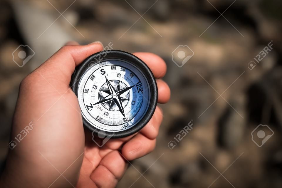 Compass in a Hand of Hiker. Useful Equipment on a Trailhead.