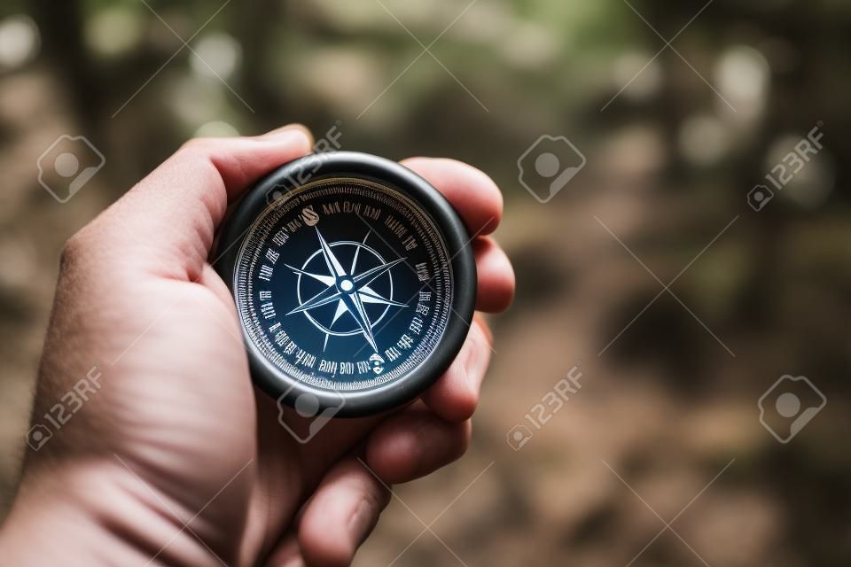 Compass in a Hand of Hiker. Useful Equipment on a Trailhead.