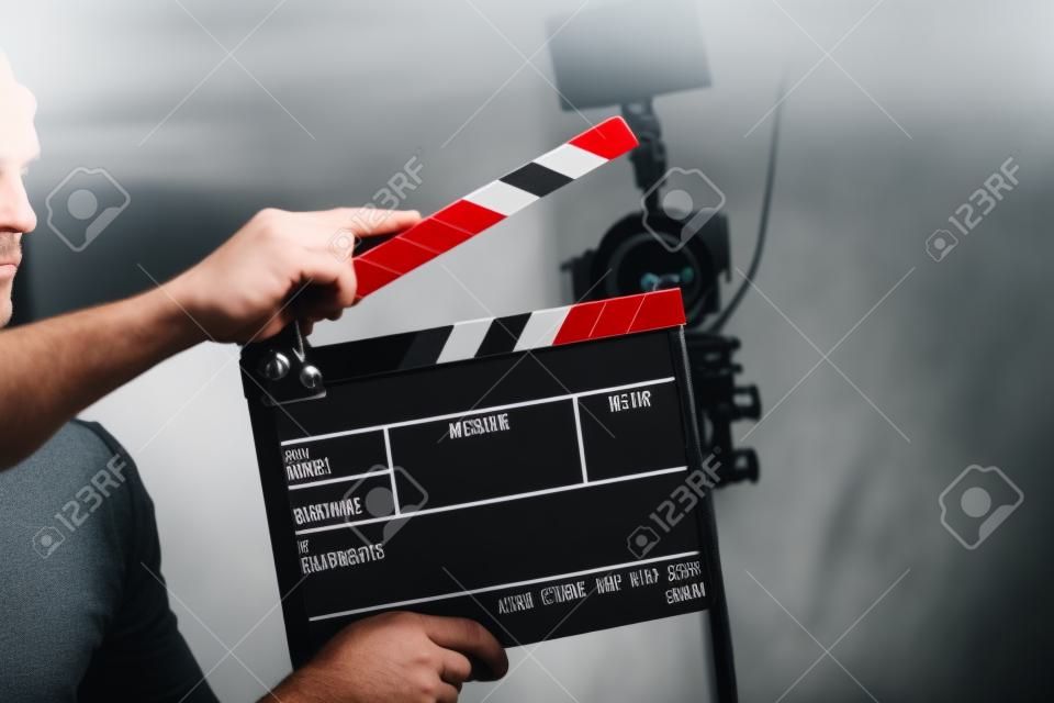 Video Production Theme. Caucasian Film Industry Worker with Clapperboard in Hands. 