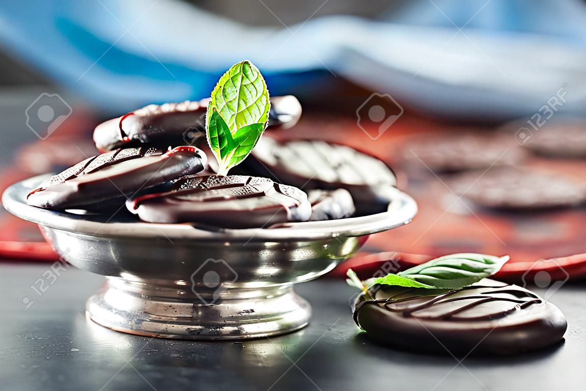 Chocolate peppermint cookies.Mint. Peppermint. Menthol. Black chocolate with peppermint cream. Black chocolate with mint stuffing. Menthol chocolate with mint leaves. Toned images.