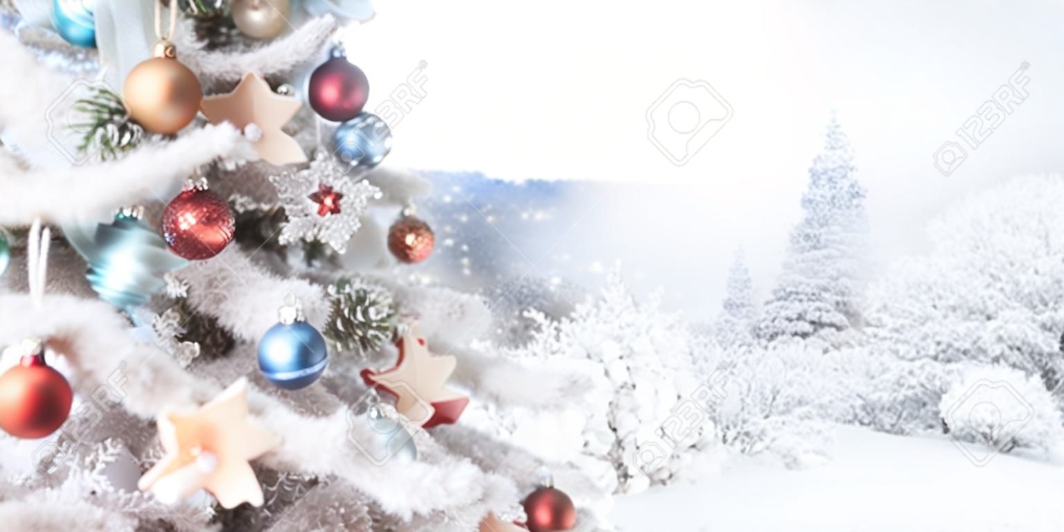 Christmas white tree decoration with Christmas toys, panoramic photo, the second part of the photo is a snowy forest in defocus, space for text. New Year card