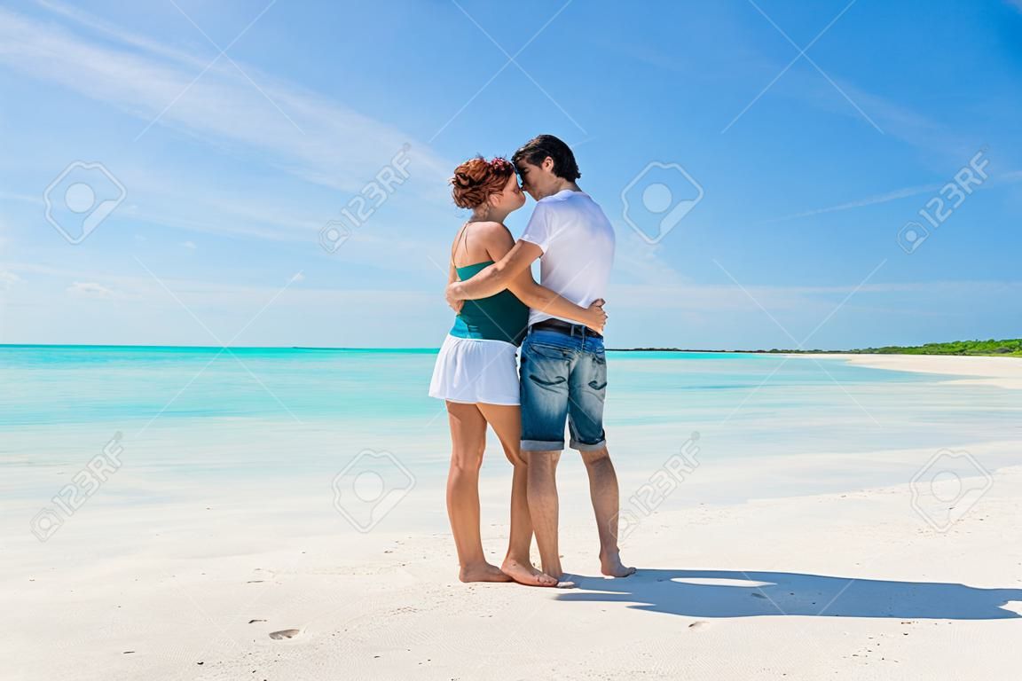 Pareja joven abrazados en una playa del Caribe