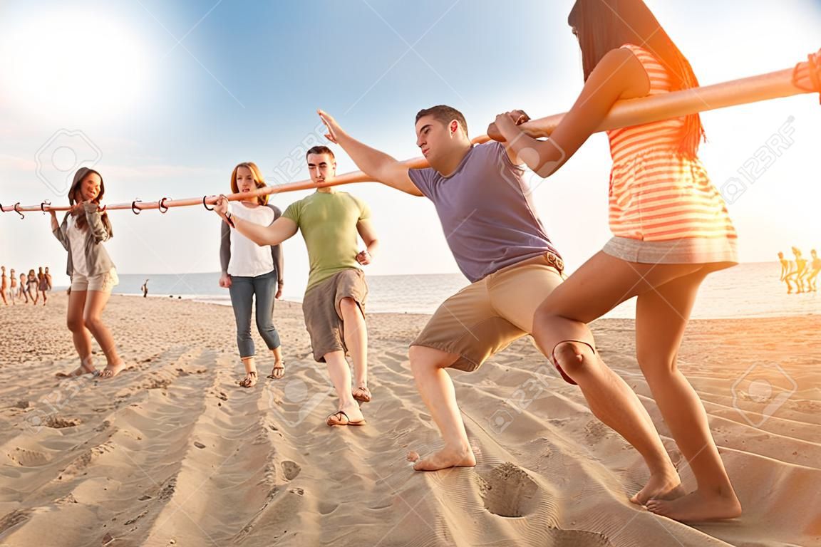 Friends Dancing Limbo at Beach