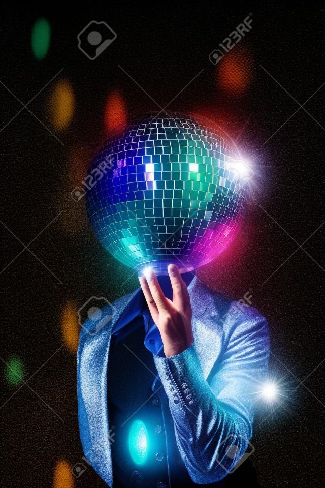 filtered image of a man holding a disco ball