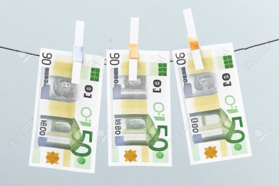 Three fifty euro bills hanging on a clothesline. Isolated on a white background.
