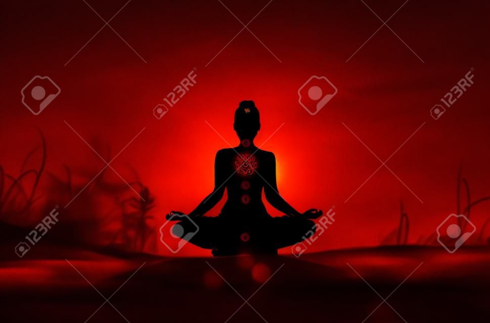 A silhouette of a person doing yoga with the root chakra symbol