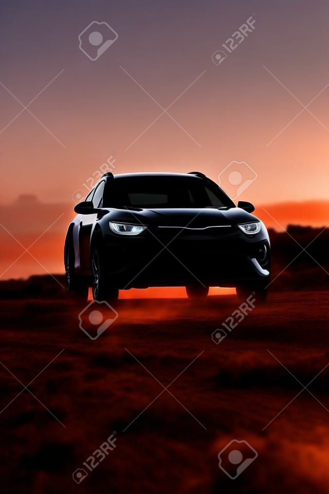 A vertical shot of a black car at sunset