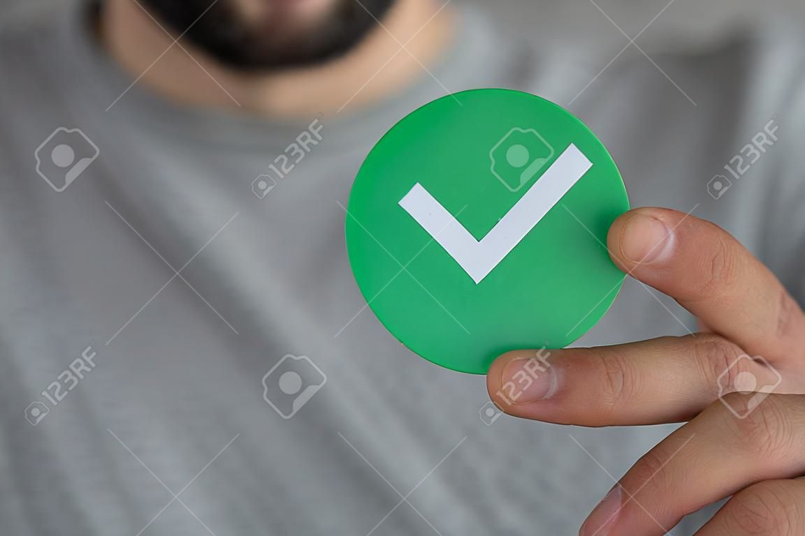A man showing a tick sign