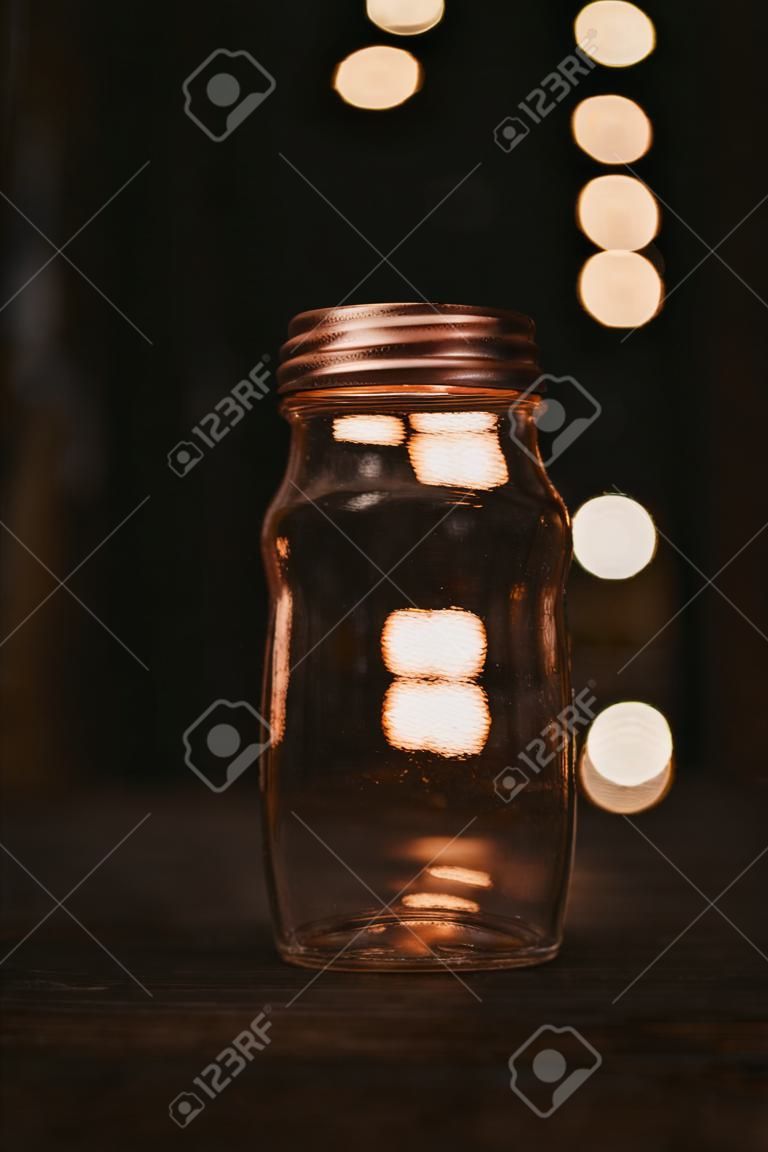 A closeup of a jar on a wooden table with soft focus background