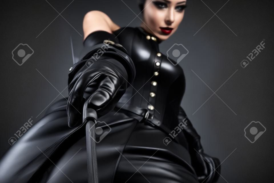 mistress with black leather outfit and whip