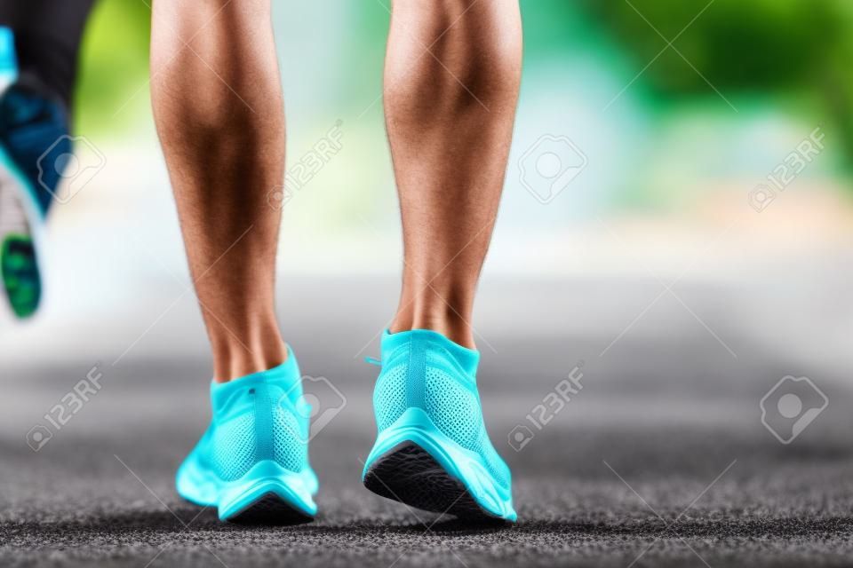 Close up of running shoes or feet sportsman runner fit body before start to running or jogging in the garden have more tree and clean air, exercising at park. Sport healthy running concept.