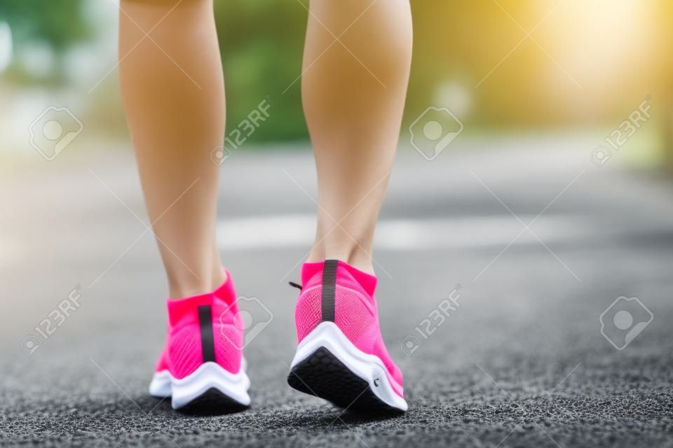 Close up of running shoes or feet sportsman runner fit body before start to running or jogging in the garden have more tree and clean air, exercising at park. Sport healthy running concept.