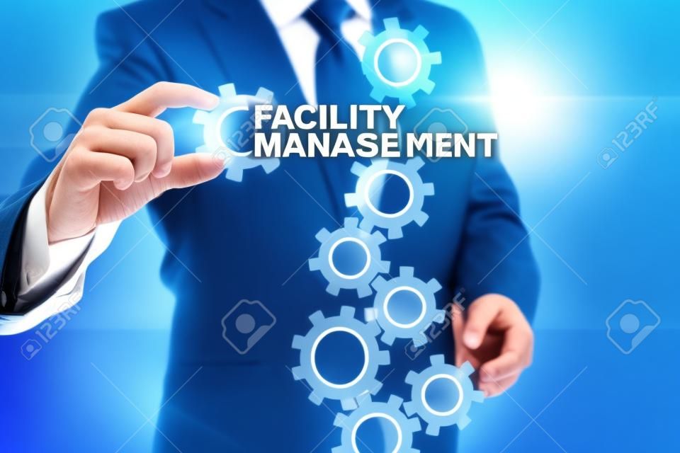 Businessman selecting facility management on virtual screen.