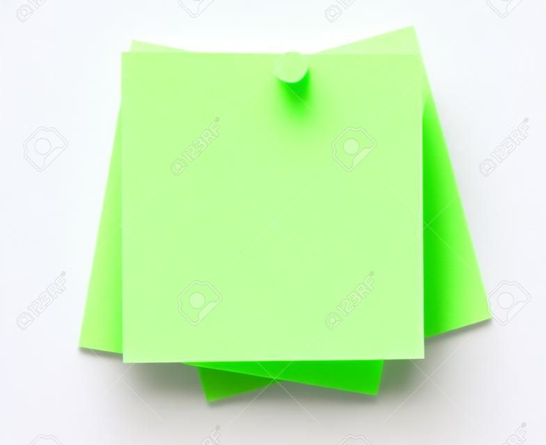 Closeup or macro of a set of blank sticky notes with pushpin isolated on white seamless background