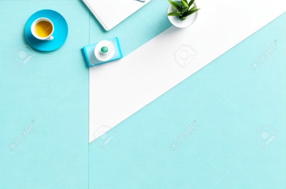 Flat lay photo of a business freelancer woman workspace desk with copy space background. Image taken from above, top view. Minimal style with colorful paper backdrop