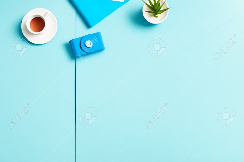 Flat lay photo of a business freelancer woman workspace desk with copy space background. Image taken from above, top view. Minimal style with colorful paper backdrop
