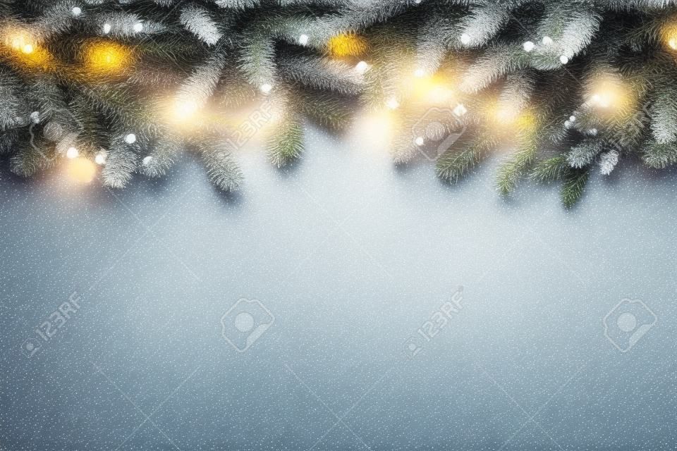 Fundo da árvore de Natal com luzes no fundo cinza claro. Cartão de ano novo com lugar para o texto. Fundo festivo da decoração.