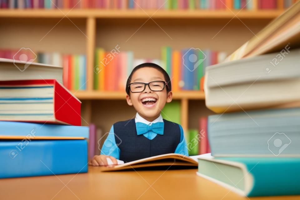 Portrait of cheerful elementary school student reading books.