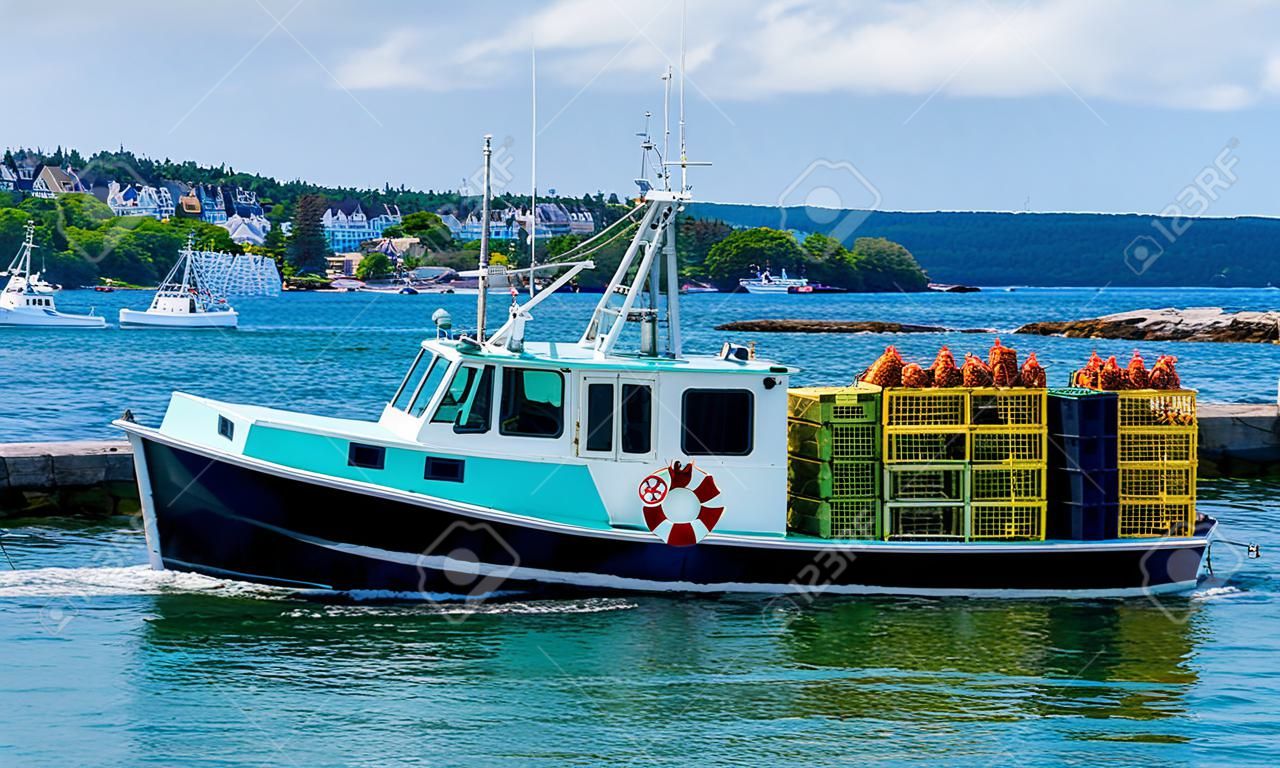 Lobster Fishing boat with lobster traps on background of the city and sea. Photography
