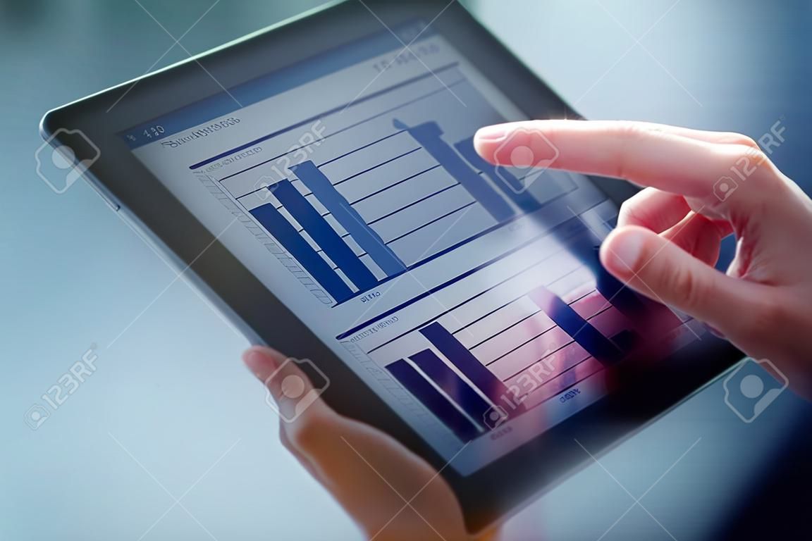 Close-up van vrouwelijke handen aanraken digitale tablet met business diagram
