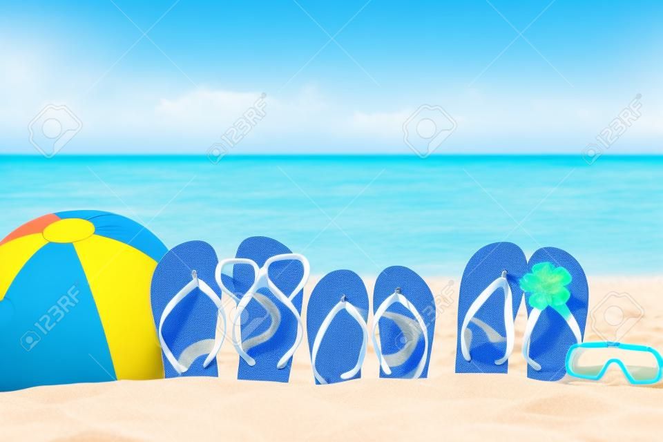 Flip-flops, beach ball and snorkel on the sand. Summer vacation concept