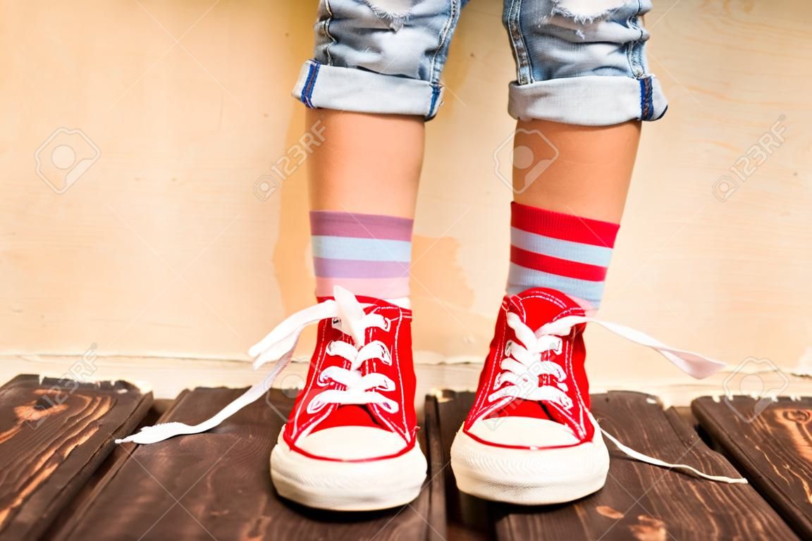 Red sneakers on children legs