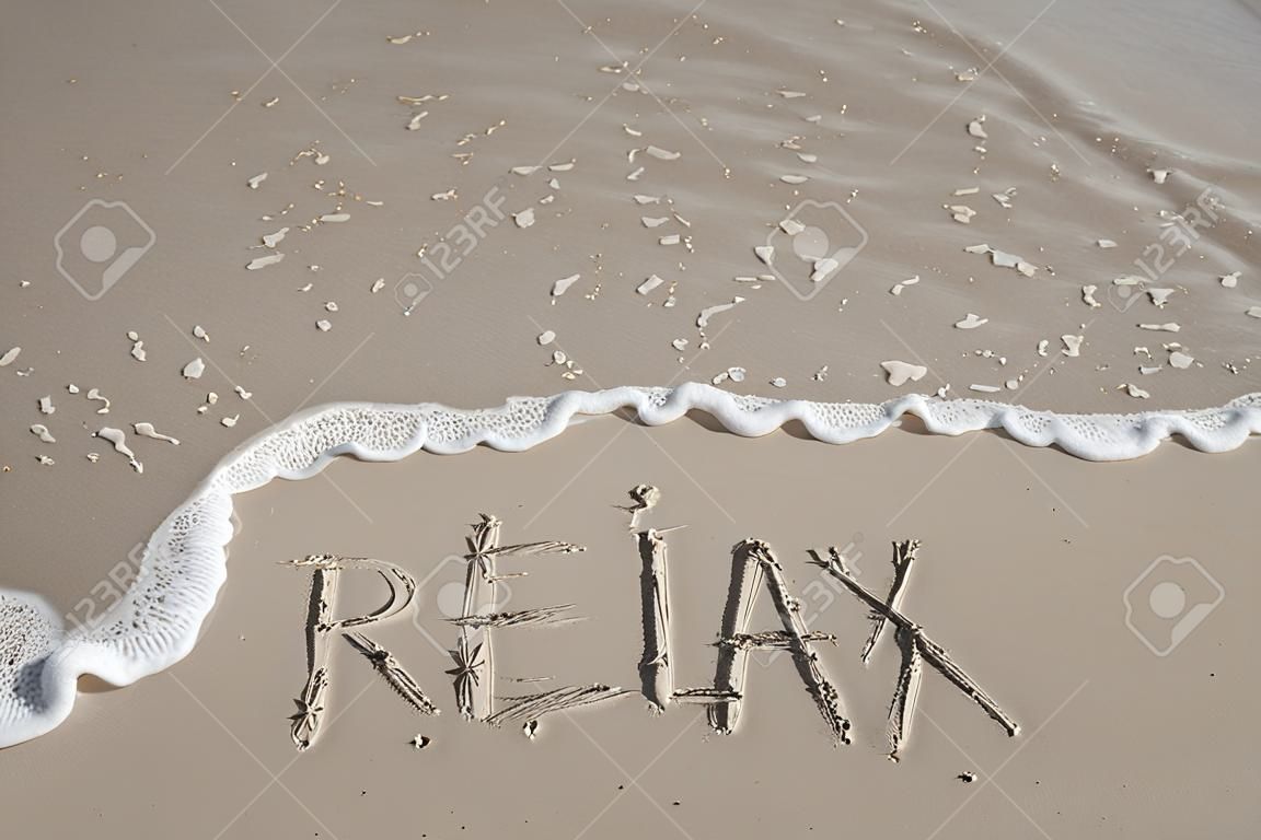 inscription Relax on a sand and a wave