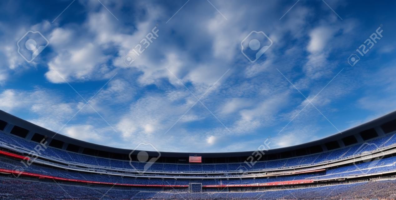 Wide Horizontal photo of a american football stadium with blue clouds in the sky