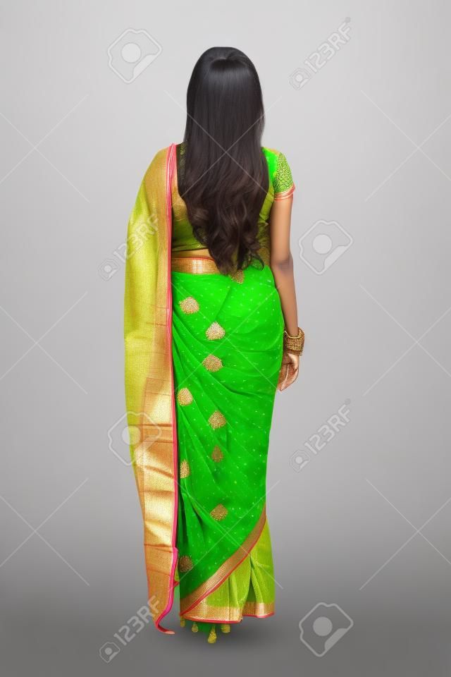 back view of indian woman in saree isolated on white background

