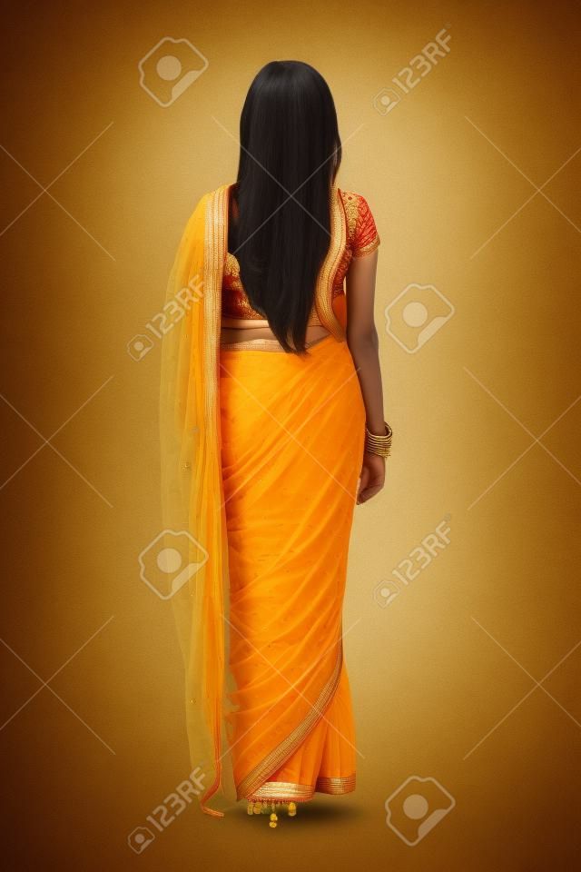 back view of indian woman in saree isolated on white background

