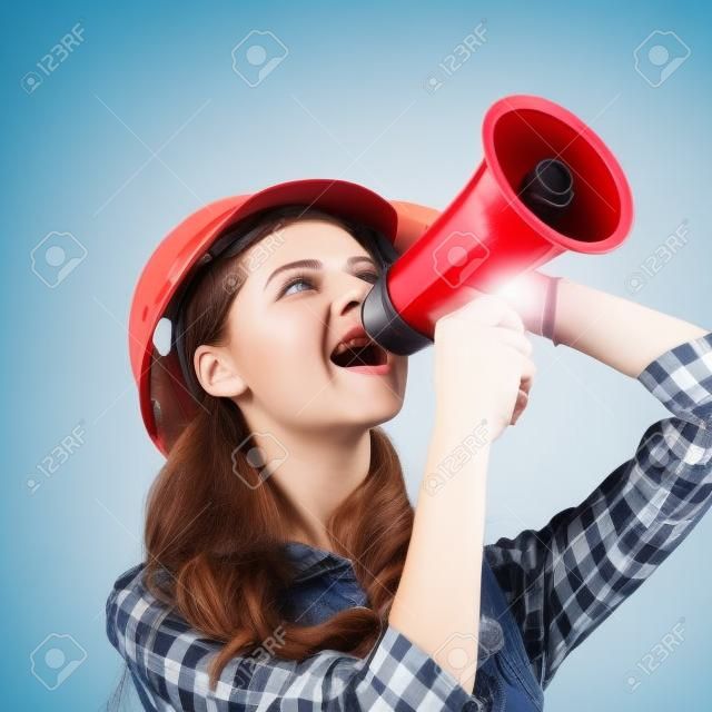 young woman engineer with a megaphone .isolated on white