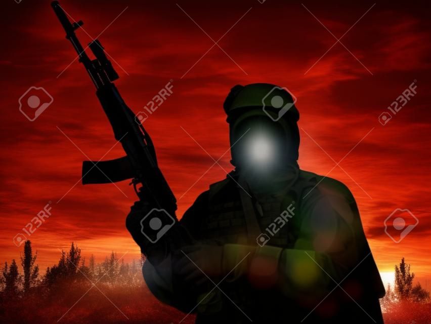 Silhouette of muslim soldier with rifle
